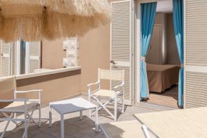 Hotel Villa Bolgheri في مارينا دي كاستانييتو كاردوتشي: غرفة بها كراسي وغرفة بها غرفة نوم