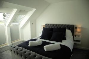 a bedroom with a large bed with two pillows on it at Southview farm in Halsham