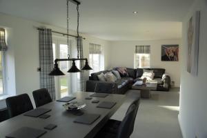 a living room with a table and a couch at Southview farm in Halsham