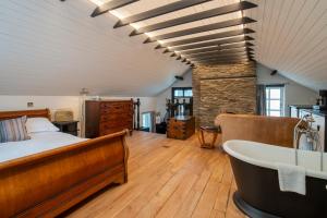 a bedroom with a bed and a tub in a room at Burgh Island Hotel in Bigbury on Sea