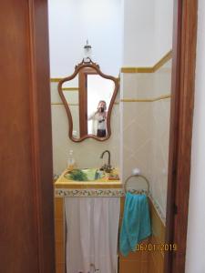 a person taking a picture of a bathroom mirror at CALLE CALVARIO 10 in Zufre