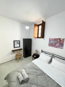 a bedroom with a large bed with towels on it at Ritsos Family Apartment in Monemvasia