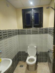 a bathroom with a toilet and a sink at Toman Pyramids hotel in Cairo