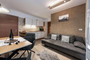 a living room with a couch and a table at Treffhof in Siusi