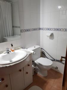 a bathroom with a sink and a toilet and a mirror at Modern, cozy studio in Fuengirola +7 photos