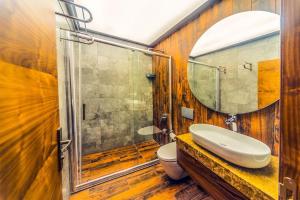 a bathroom with a sink and a toilet and a mirror at Inanlar Premium Suites & Villas in Uzungöl +18 photos