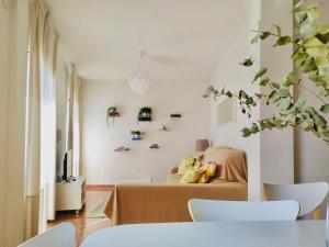 a living room with a bed and a tv at Apartamento Peñuelas in Seville