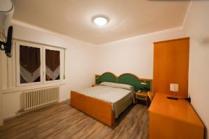 Postel nebo postele na pokoji v ubytování AlmaMed Hotel san Leonardo