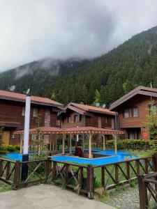 a resort with a table in front of a building at Inanlar Premium Suites & Villas in Uzungöl