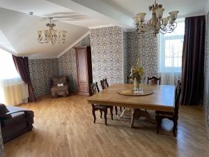 a living room filled with furniture and a table at Complex Zolota Pidkova in Zolochiv