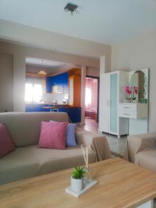 a living room with a couch and a table at Iliada's apartment in Polychrono