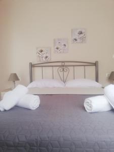 a bedroom with a large bed with white pillows at Iliada's apartment in Polychrono
