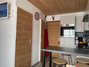 a kitchen with a table and chairs in a room at residence les Ravieres 1 in La Toussuire