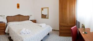 Postel nebo postele na pokoji v ubytování Hotel Elisabetta