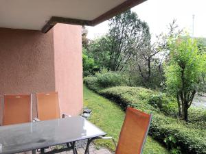 a table and chairs on a patio with a garden at Centrally located, Spacious Modern Apartment in Zürich