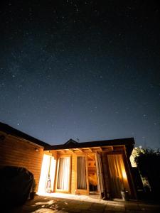 a house at night with a starry sky at Moors Wood Relaxing ,Tranquil retreat with Hot Tub in Chippenham