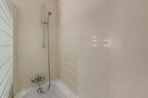 a shower with a glass door in a bathroom at Dragon Stadium Studio w Balcony by LovelyStay in Porto +9 photos