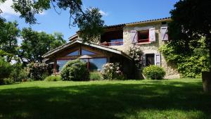 una casa con un césped verde delante de ella en Terres de Barréjat, en Cazals-des-Baylès