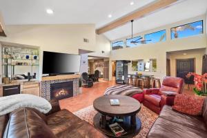 a living room with a couch and a fireplace at Spectacular condo with private golf privileges includes golf cart on Monterey Country Club !! in Palm Desert