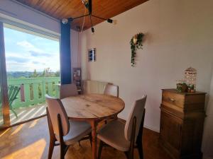 a dining room with a table and chairs and a window at Studio avec superbe vue 5min à pied des Thermes in Bagnoles de l'Orne