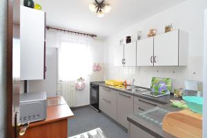 a kitchen with white cabinets and a sink at Apartments Anka 1223 in Peroj