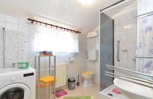 a bathroom with a washing machine and a toilet at Apartments Anka 1223 in Peroj +134 photos
