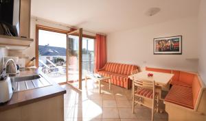 a kitchen and living room with a couch and a table at Apartments Elisir in Castelrotto +11 photos