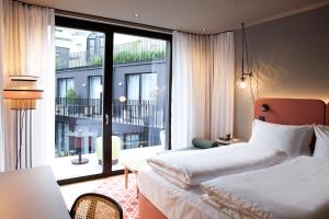 Postel nebo postele na pokoji v ubytování Hotel Indigo Vienna - Naschmarkt by IHG + 52 fotografií