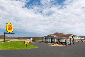 a gas station with a sign in front of it at Super 8 by Wyndham Newcomerstown in Newcomerstown
