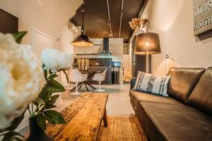 a living room with a couch and a table at Short Stay Apartments Heerenveen in Heerenveen