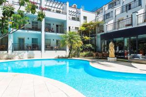 a large swimming pool in front of a building at Esplanade Hotel Fremantle - by Rydges in Fremantle