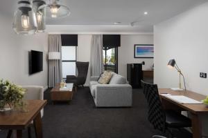 ein Wohnzimmer mit einem Sofa und einem Tisch in der Unterkunft Esplanade Hotel Fremantle - by Rydges in Fremantle