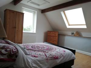 a bedroom with a bed and a window at Cuilcagh House in Blacklion