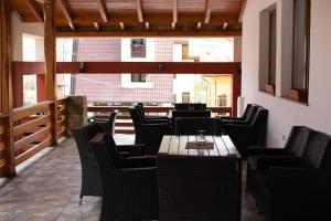 a restaurant with a wooden table and chairs at Bicaz-Chei in Bicaz Chei