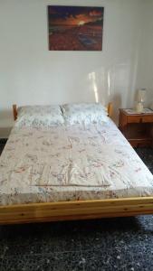 a bed sitting in a bedroom with a bed frame at Nature of Karapata in Koroni