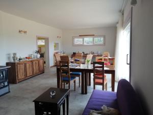 a kitchen and dining room with a table and chairs at LES JARDINS CELESTES in Saint-Genest-de-Bauzon