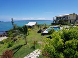 a house with a swimming pool next to the ocean at Villas Vetiver in Rodrigues Island