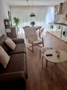 a living room with a couch and a table at Ría de Navia in Navia