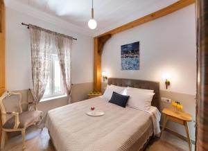 sypialnia z łóżkiem z krzesłem i stołem w obiekcie Avali Design Suites w mieście Leukada (miasto)