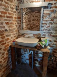 a bathroom with a sink on a wooden table at Campingul Apusenilor in Şuncuiuş