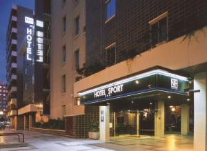 a hotel with a sign on the front of a building at NH Sport in Zaragoza