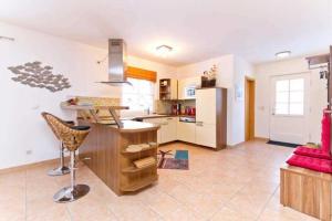 a kitchen with a island in the middle of a room at Ferienhaus Reethaus Koserow in Ostseebad Koserow