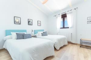 two beds in a room with white walls at Villa Maria in Murcia +42 photos