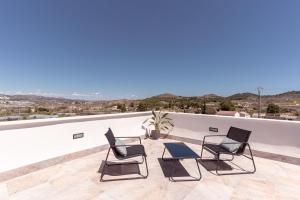 a group of chairs sitting on top of a roof at Villa Maria in Murcia