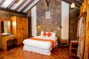 a bedroom with a large bed in a room at Naro Moru River Lodge in Naro Moru