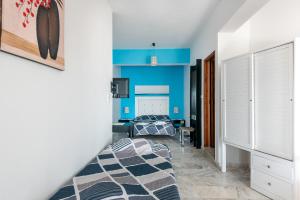a bedroom with blue walls and a bed at Angela Apartments new listing in Marathi