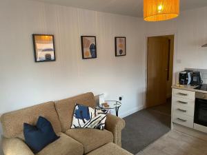 a living room with a couch and a table at Private Cosy 1Bd in town in Fareham