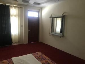 ein Zimmer mit einer Tür, einem Bett und einem Fenster in der Unterkunft SWAT HiLL ViEW RESORT-only for families in Swat + 102 Fotos
