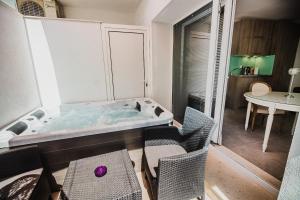 a bathroom with a tub with a table and chairs at Downtown Luxury Apartments with Hot Tub in Vodice +61 photos