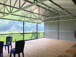 a large empty room with chairs and a balcony at Hoàng Quân Homestay in Ba Be +67 photos
